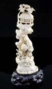 A Japanese walrus ivory okimono, early 20th century, carved as a lady holding a parasol walking by