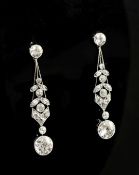 A good pair of 1920's platinum and diamond drop earrings, with tapering stems and millegrain set