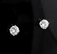 A pair of 14ct white gold and solitaire diamond ear studs, each round brilliant cut stone weighing