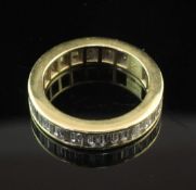 An 18ct gold and diamond full eternity ring, with channel set baguette cut diamonds, size K.