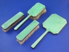 A 1930's Art Deco silver and green guilloche enamel four piece dressing table set by Mappin &