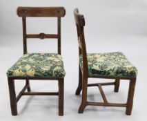 A set of four Victorian gothic dining chairs, the crest rails with floral rosettes, the central spar