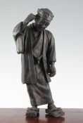 A Japanese bronze figure of an old man, 19th century, scratching his ear with his right hand and