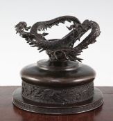 A Japanese bronze bowl and stand, 19th century, the stepped circular bowl cast in relief with