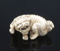 A Japanese ivory netsuke of a shi-shi, signed Ichimin, early Meiji period, with snarling