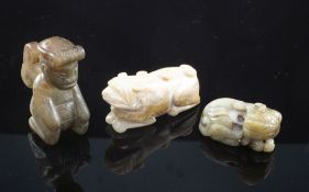 A Chinese grey jade figure of a recumbent lion-dog and two other jade figures, 19th century and