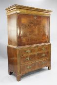 An 18th century walnut escritoire, with unusual hinged cushion frieze revealing pigeon holes above a