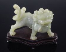 A Chinese bowenite jade figure of a lion-dog, 20th century, 11cm, wood stand