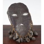 A tribal carved bone mask, probably African Democratic Republic of Congo, 8.5in.