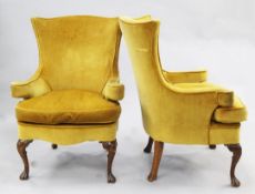 A pair of George I style walnut armchairs with scroll arms and shell kneed cabriole legs