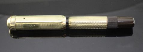 A gold plated Montblanc vintage safety pen with engine turned decoration, 4in.