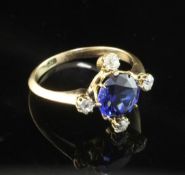 A gold, sapphire and diamond ring, the central round cut blue sapphire of good colour and bordered