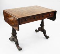 A Regency mahogany sofa table, with two frieze drawers opposing two dummy drawers, stiff leaf vase