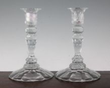 Three George III style facet cut glass candlesticks, with double knopped stems on petal shaped