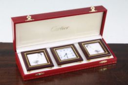 A Must de Cartier desk set, comprising a timepiece and a pair of photograph frames, in original