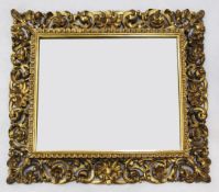 A 19th century rectangular Florentine giltwood wall mirror, with acanthus carved and shou