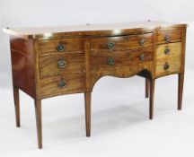 A George III mahogany serpentine sideboard, fitted with an arrangement of drawers, on square section