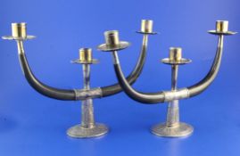 A pair of mid 20th century Eastern silver and horn two branch, three light candelabra, with engraved