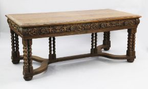 A 17th century style Flemish carved oak library table, with two drawers opposing two further