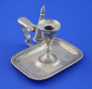 A late Victorian silver chamberstick and snuffer, of rectangular form, with gadrooned border,