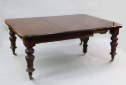 A Victorian mahogany extending dining table, with three extra leaves on stiff leaf turned legs and