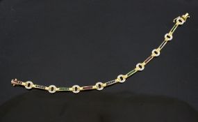 An 18ct gold, ruby, emerald, sapphire and diamond set bracelet, of alternating gem set ring and