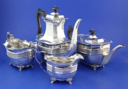 A late Victorian matched four piece silver tea and coffee set and pair of tongs, of oval form with