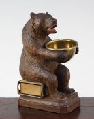 A Black Forest carved bear match tidy, with brass bowl, 5.5in.