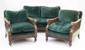 An Edwardian mahogany three piece bergere suite, with green upholstered back and seats with double