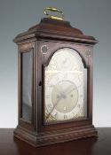 A George III mahogany bracket clock, with plain case and arched brass dial, inset with silvered