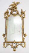 A George III giltwood carved and gesso wall mirror, with pierced scrolling eagle mounted crest and