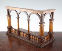 A treen architectural book stand, modelled as an arched balustrade, with tapering columns, 16in.