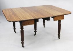 A Regency mahogany extending dining table, with D shaped ends and two leaves, on turned fluted