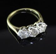 A gold and three stone diamond ring, the three round brilliant cut stones with a total diamond