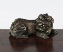 A Chinese bronze 'lion-dog' scroll weight, 19th century, cast in recumbent pose, with engraved