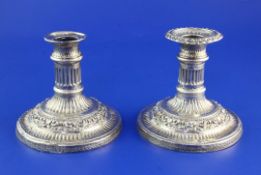 A pair George IV silver dwarf candlesticks by John & Thomas Settle, with extensive repousse fluted