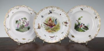 Two Meissen outside decorated plates and a similar Berlin outside decorated plate, each painted with