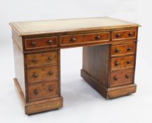 A late Victorian mahogany pedestal desk, the top with brown leather skiver above nine drawers, the