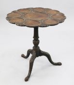 A George III style mahogany supper table, with circular lobed top on central turned column and