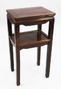 A Chinese rosewood two tier rectangular side table or urn stand, with square section tapering