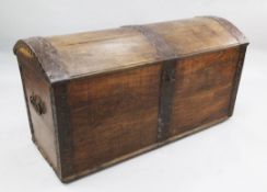 A large 19th century French iron bound oak dome top trunk, the front decorated with two