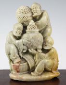 A Chinese soapstone group of three Luohan, 20th century, each holding a precious object, the pale