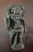 An Indian hardwood figural relief, 18th century or earlier, depicting a Hindu god in standing pose