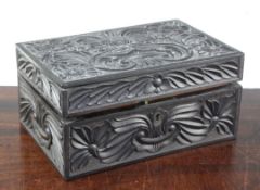 A 19th century Ceylonese carved ebony work box, decorated all over with flowerheads and scrolling