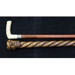An early 20th century bone handled sword stick, with blued steel floral decoration, together with