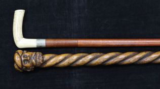 An early 20th century bone handled sword stick, with blued steel floral decoration, together with