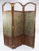 A late Victorian mahogany three fold screen, with arched bevelled glass above coloured embossed