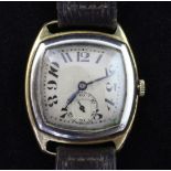 A gentleman's stylish mid 1920's 18ct gold manual wind wrist watch, with silvered dial, tumbling