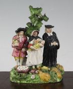 A pearlware 'The Tithe Pig' group, early 19th century, the three figures standing before a tree,