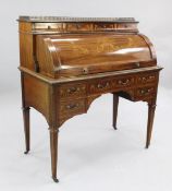 An Edwardian mahogany and marquetry inlaid cylinder bureau, fitted with an arrangement of drawers,